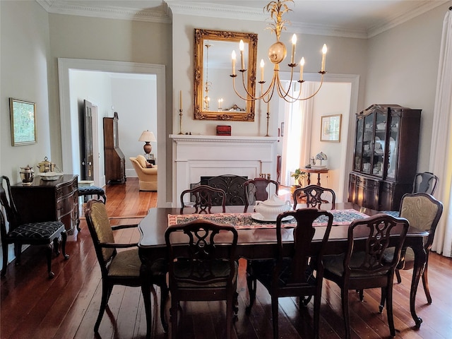 dining space with a notable chandelier, hardwood / wood-style flooring, and crown molding