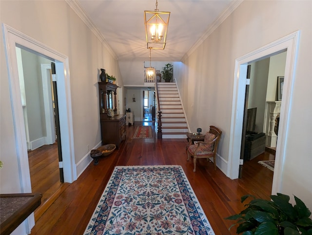 hall with lofted ceiling, a chandelier, dark hardwood / wood-style floors, and crown molding