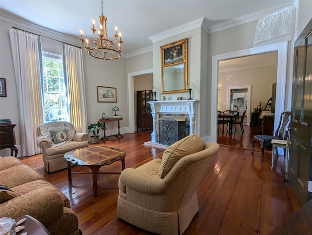 living room with crown molding, a chandelier, and hardwood / wood-style flooring