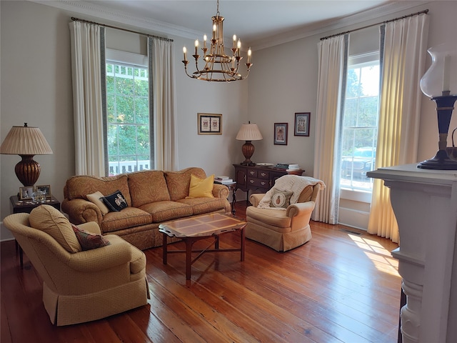 living room featuring wood-type flooring, a chandelier, and a healthy amount of sunlight