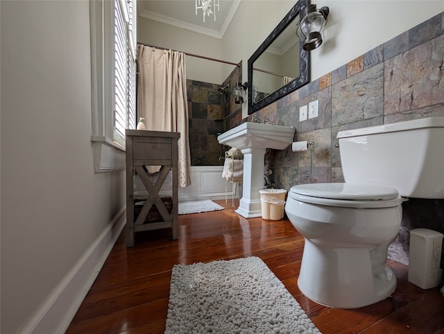 bathroom featuring tile walls, toilet, ornamental molding, hardwood / wood-style floors, and a shower with curtain