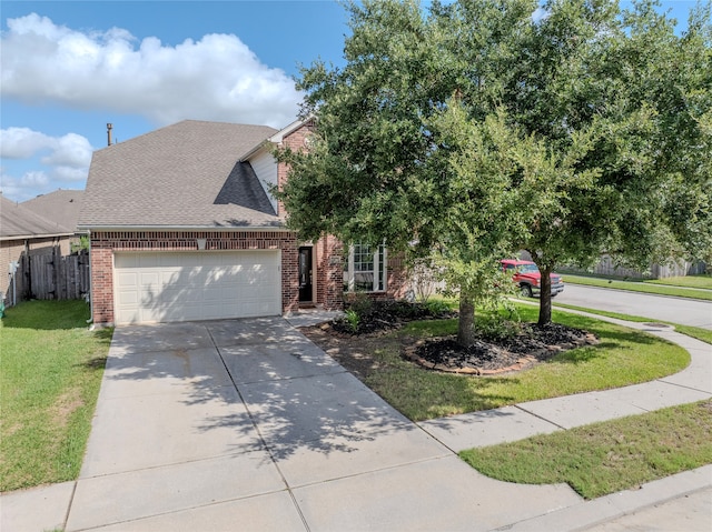 view of front of home with a front lawn and a garage