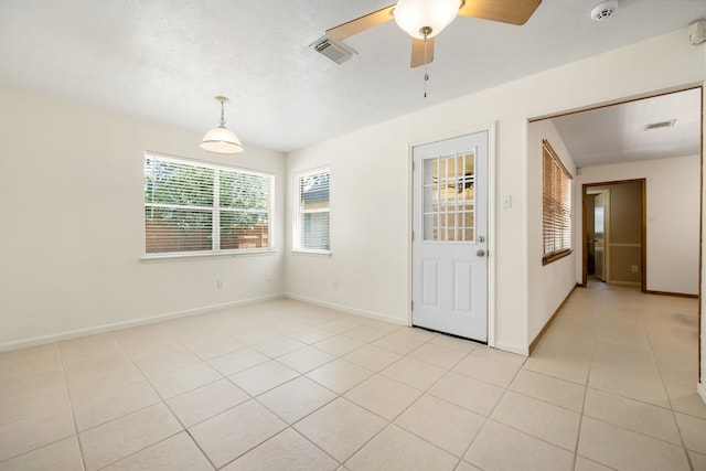 unfurnished room with ceiling fan and light tile patterned floors