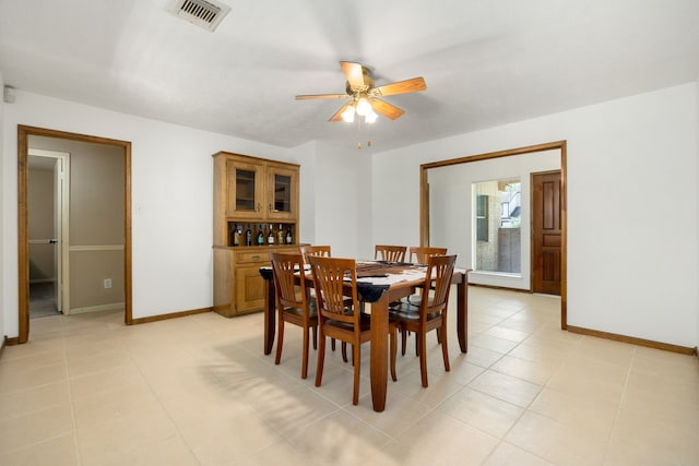 tiled dining room featuring ceiling fan