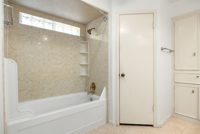 bathroom featuring tiled shower / bath combo and tile patterned flooring