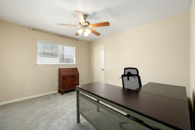 office space with ceiling fan and light colored carpet