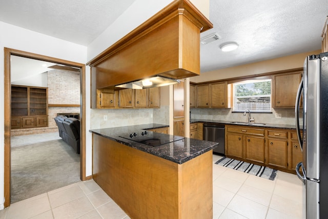 kitchen with black appliances, kitchen peninsula, light tile patterned flooring, and sink