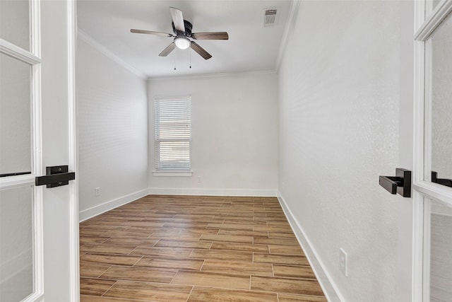 spare room featuring crown molding, ceiling fan, and light wood-type flooring