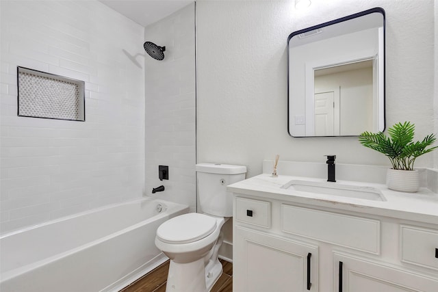 full bathroom featuring wood-type flooring, vanity, toilet, and tiled shower / bath