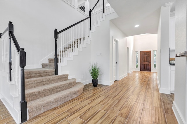 interior space with a towering ceiling and light wood-type flooring