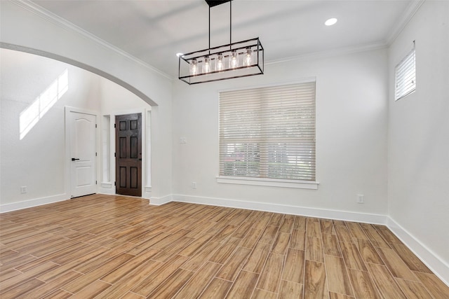 unfurnished room featuring light wood-type flooring, an inviting chandelier, and plenty of natural light