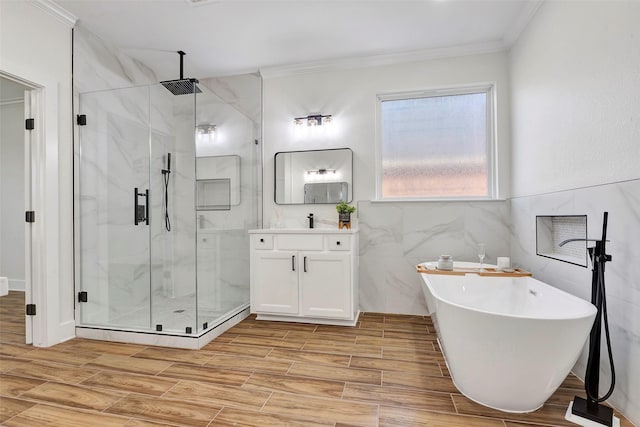 bathroom featuring shower with separate bathtub, vanity, tile walls, and crown molding