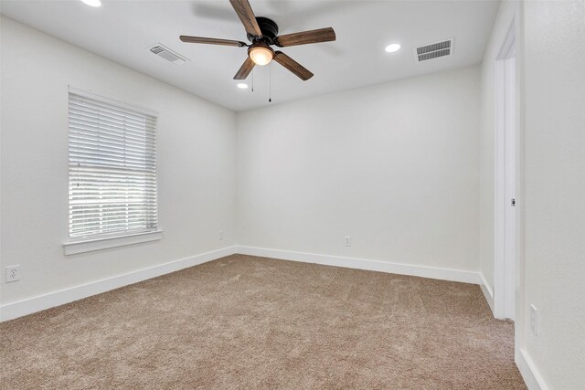 spare room featuring ceiling fan and carpet floors