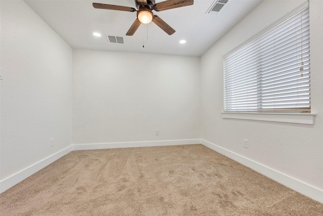 carpeted spare room featuring ceiling fan