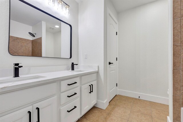 bathroom featuring tile patterned flooring and vanity