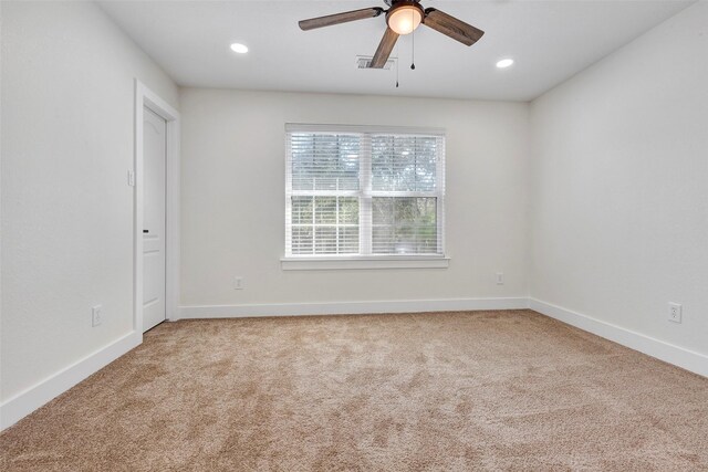 unfurnished room featuring light colored carpet and ceiling fan