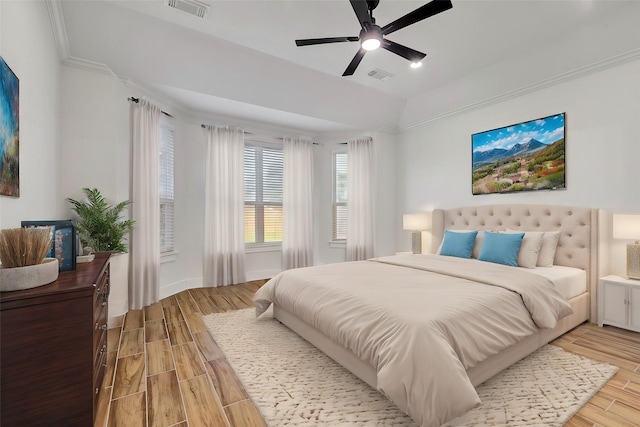 bedroom featuring ceiling fan, crown molding, and light hardwood / wood-style floors