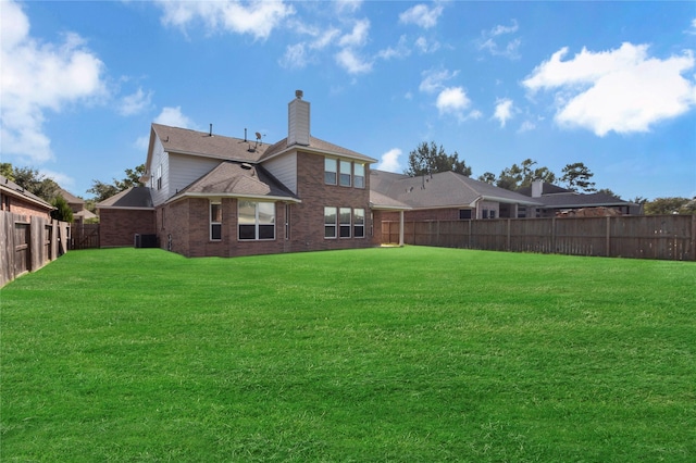 back of house featuring a lawn