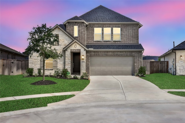 view of front facade featuring a lawn and a garage