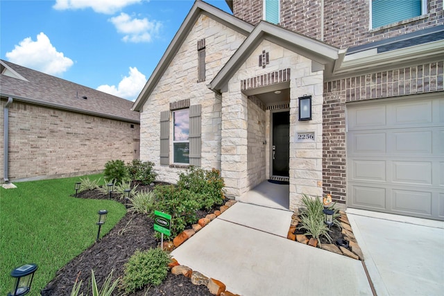 doorway to property with a lawn and a garage