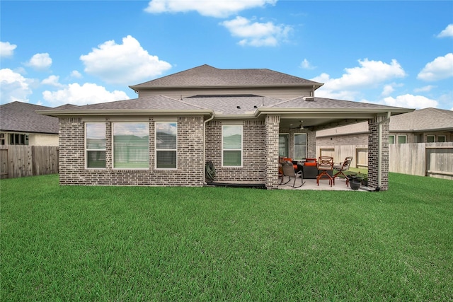 back of property featuring a patio area and a lawn