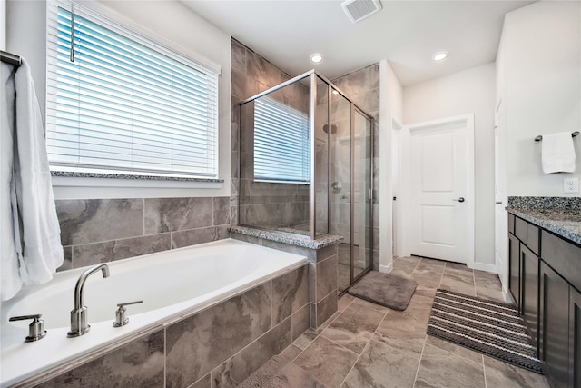 bathroom with plus walk in shower and vanity