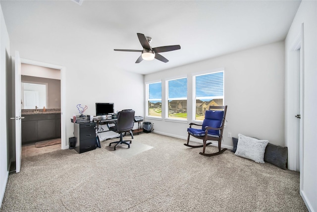 carpeted office with ceiling fan and sink