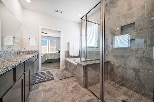 bathroom featuring vanity and shower with separate bathtub