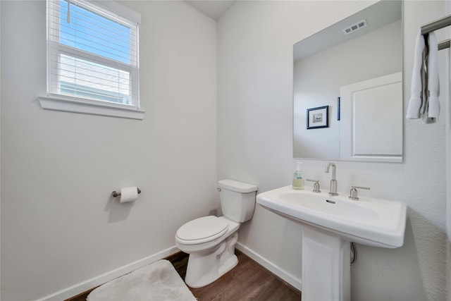 bathroom featuring hardwood / wood-style flooring and toilet