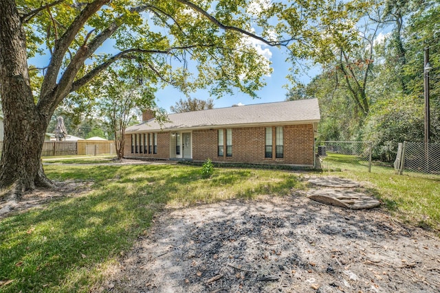 back of property with a lawn