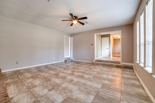 spare room with a wealth of natural light and ceiling fan