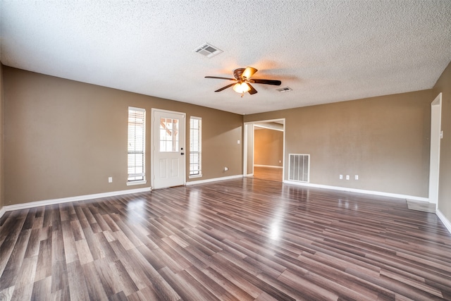 spare room featuring ceiling fan, dark hardwood / wood-style floors, and a textured ceiling