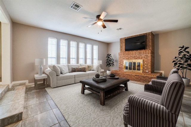 tiled living room with a brick fireplace and ceiling fan