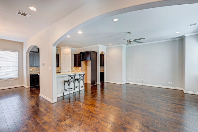 living room with ceiling fan, dark hardwood / wood-style flooring, and crown molding