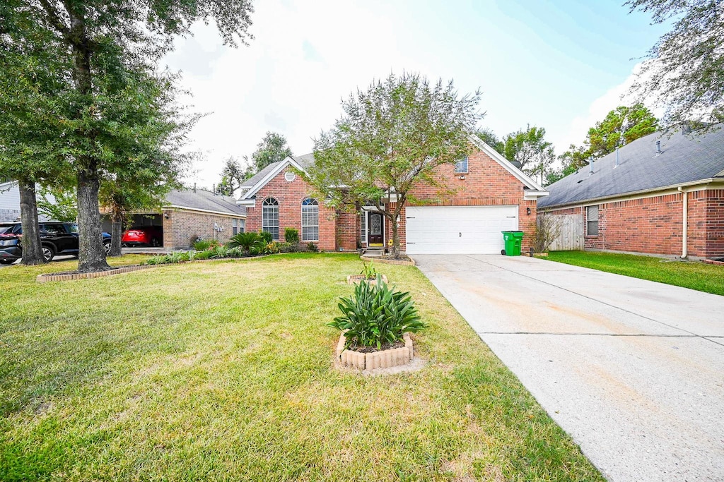 711 Far Pines Dr, Spring, TX 77373 - view of front of home featuring a front yard, brick siding, concrete driveway, and an attached garage