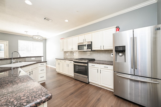 kitchen featuring dark hardwood / wood-style flooring, stainless steel appliances, white cabinets, and sink