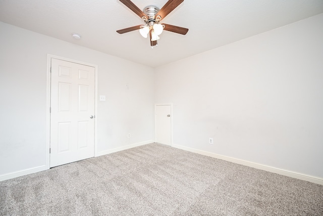 empty room with ceiling fan and carpet flooring