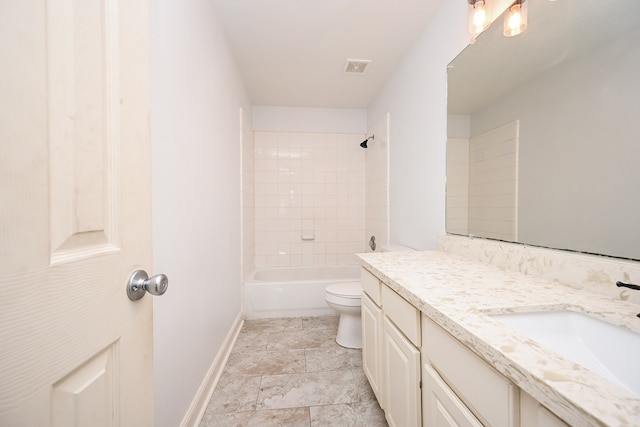 full bathroom featuring vanity, tiled shower / bath combo, and toilet