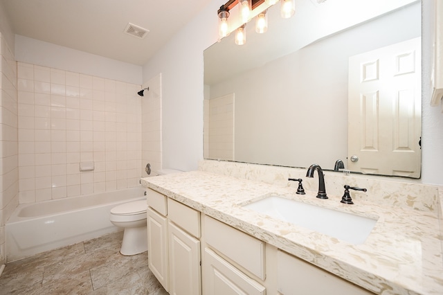 full bathroom with vanity, toilet, and tiled shower / bath