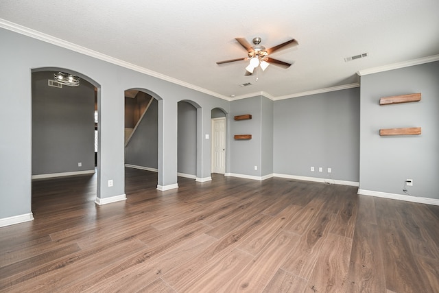 spare room with a textured ceiling, ornamental molding, dark hardwood / wood-style flooring, and ceiling fan