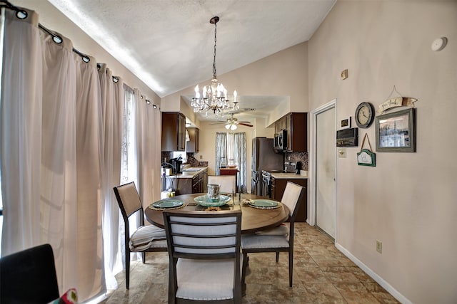 dining area with a textured ceiling, ceiling fan with notable chandelier, and high vaulted ceiling