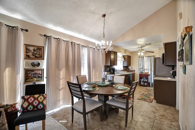 dining room with ceiling fan with notable chandelier, lofted ceiling, a textured ceiling, and sink