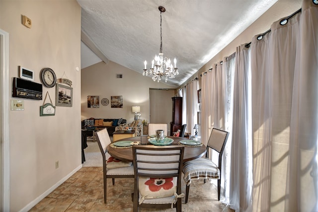 dining space featuring vaulted ceiling, a textured ceiling, and a chandelier