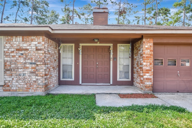 doorway to property featuring a porch and a garage