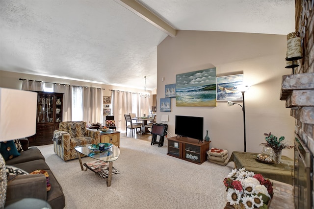 living room with a textured ceiling, a notable chandelier, carpet, vaulted ceiling with beams, and a stone fireplace