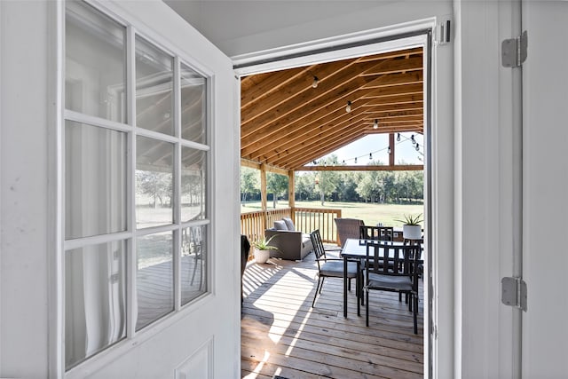 exterior space with wood-type flooring and vaulted ceiling