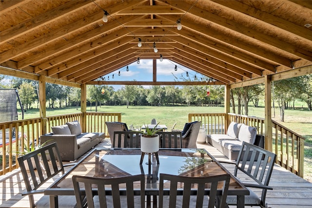 wooden deck featuring an outdoor hangout area, a gazebo, and a yard