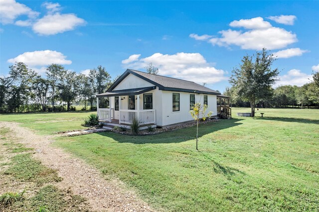 view of property exterior featuring a lawn and covered porch