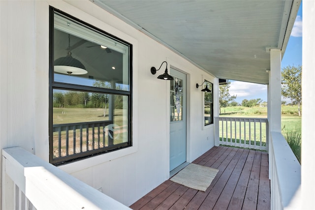 wooden terrace featuring ceiling fan