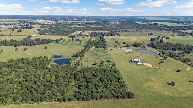 drone / aerial view featuring a water view and a rural view